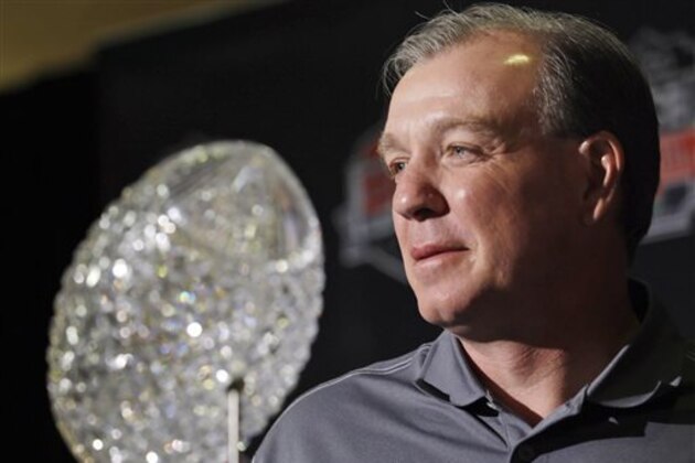 Florida State head coach Jimbo Fisher poses with The Coaches' Trophy during a news conference for the BCS National Championship NCAA college football game Tuesday, Jan. 7, 2014, in Newport Beach, Calif. Florida State beat Auburn 34-31 to win the championship the night before. (AP Photo/Morry Gash)