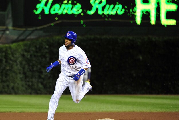 Jul 29, 2014; Chicago, IL, USA; Chicago Cubs third baseman Emilio Bonifacio (64) runs the bases after hitting a two-run home run  against the Colorado Rockies during the fourth inning at Wrigley Field. Mandatory Credit: David Banks-USA TODAY Sports