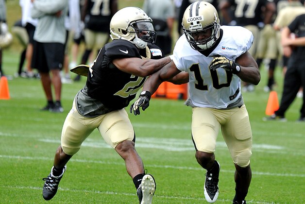 New Orleans Saints wide receiver Brandin Cooks (10) pushes off New Orleans Saints cornerback Patrick Robinson (21) during there NFL football training camp inWhite Sulphur Springs , W. Va., Sunday, July 27, 2014. (AP Photo/Chris Tilley)