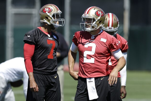 San Francisco 49ers quarterbacks Colin Kaepernick (7) and Blaine Gabbert (2) walk on the practice field during NFL football mini-camp in Santa Clara, Calif., Wednesday, June 18, 2014. (AP Photo/Jeff Chiu)