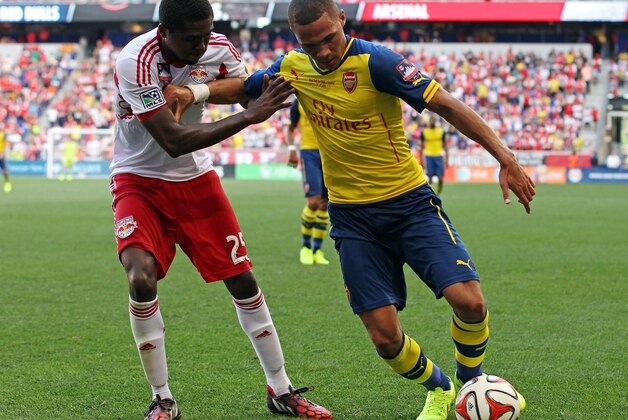 New York Red Bulls defender Chris Duvall, left, vies for the ball with Arsenal defender Bacary Sagna during the second half of an international friendly soccer match Saturday, June 26, 2014, in Harrison, N.J. The Red Bulls won 1-0. (AP Photo/Adam Hunger)