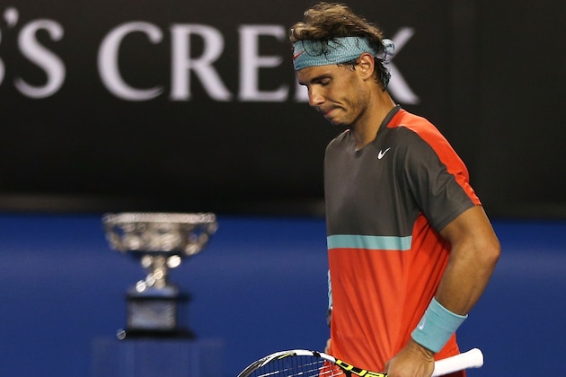 MELBOURNE, AUSTRALIA - JANUARY 26:  Rafael Nadal of Spain reacts as he appears to be injured in his men's final match against Stanislas Wawrinka of Switzerland during day 14 of the 2014 Australian Open at Melbourne Park on January 26, 2014 in Melbourne, Australia.  (Photo by Clive Brunskill/Getty Images)