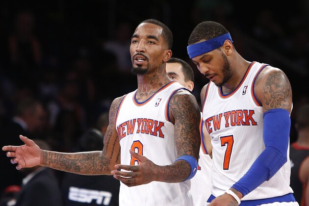 New York Knicks' J.R. Smith (8) talks with teammate Carmelo Anthony (7) as they walk off the court during a timeout late in the fourth quarter of an NBA basketball game against the Miami Heat, Saturday, Feb. 1, 2014, in New York. Miami won 106-91. (AP Photo/Jason DeCrow)