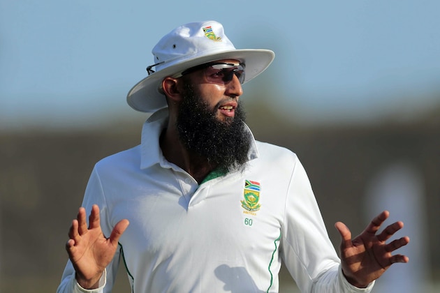 South Africa's test cricket captain Hashim Amla gestures to a teammate during the second day of the first test cricket match between Sri Lanka and South Africa in Galle, Sri Lanka, Thursday, July 17, 2014. (AP Photo/Eranga Jayawardena)