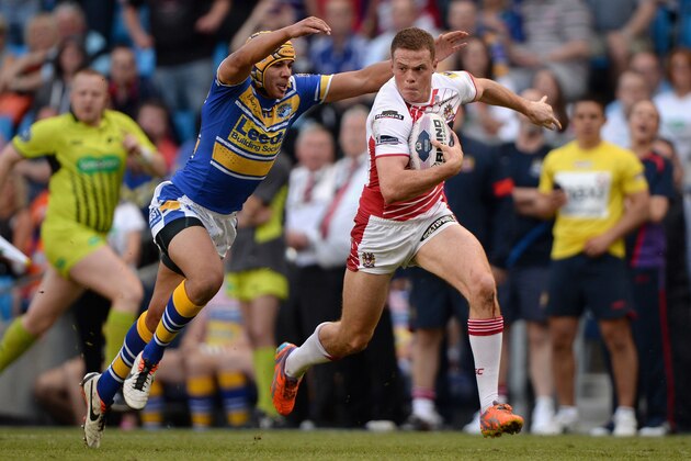 MANCHESTER, ENGLAND - MAY 17:  Joe Burgess of Wigan Warriors gets past Ben Jones-Bishop of Leeds Rhinos during the Super League match between Wigan Warriors and Leeds Rhinos at Etihad Stadium on May 17, 2014 in Manchester, England.  (Photo by Gareth Copley/Getty Images)
