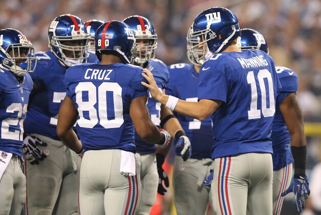 Sep 8, 2013; Arlington, TX, USA; New York Giants quarterback Eli Manning talks with receiver Victor Cruz (80) runs after a catch against the Dallas Cowboys at AT&T Stadium. Mandatory Credit: Matthew Emmons-USA TODAY Sports
