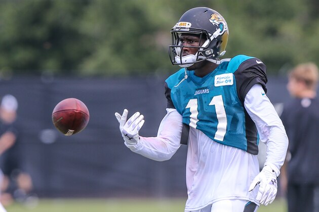 Jacksonville Jaguars receiver Marqise Lee (11) tosses the ball at the end of the play during NFL football practice, first day with pads on Wednesday, July 30, 2014 in Jacksonville, Fla. (AP Photo/Gary McCullough)