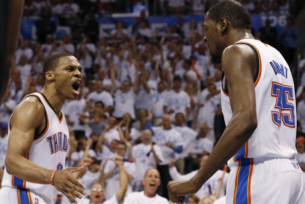 Oklahoma City Thunder's Russell Westbrook (0) and Kevin Durant (35) celebrate during the first half of Game 6 against the San Antonio Spurs in the Western Conference finals NBA basketball playoff series in Oklahoma City, Saturday, May 31, 2014. (AP Photo/Sue Ogrocki)