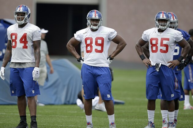 New York Giants' Larry Donnell, left, Xavier Grimble, center, and Daniel Fells during a NFL football camp in East Rutherford, N.J., Wednesday, July 23, 2014. (AP Photo/Seth Wenig)