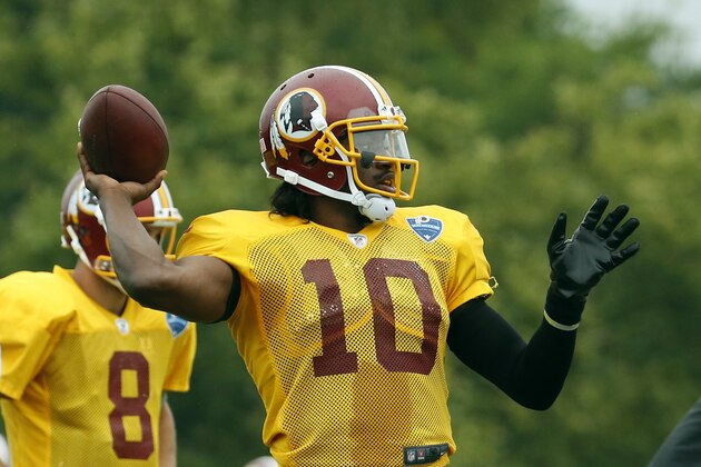 Washington Redskins quarterback Robert Griffin III prepares to throw during practice at the team's NFL football training facility, Sunday, July 27, 2014 in Richmond, Va. (AP Photo/Alex Brandon)