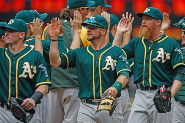 SEATTLE, WA - JULY 13:  Members of the Oakland Athletics celebrate after defeating the Seattle Mariners 4-1 at Safeco Field on July 13, 2014 in Seattle, Washington.  (Photo by Otto Greule Jr/Getty Images)