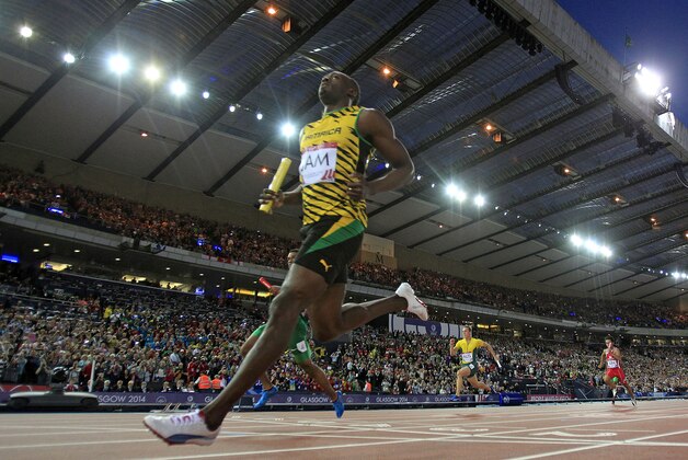 Usain Bolt of Jamaica crosses the finish line during the first round 4x100m relay at Hampden Park Stadium during the Commonwealth Games 2014 in Glasgow, Scotland, Friday Aug. 1, 2014. (AP Photo/Frank Augstein)