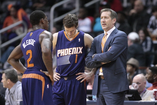 Phoenix Suns head coach Jeff Hornacek, right, talks with Phoenix Suns guard Eric Bledsoe (2) and Phoenix Suns guard Goran Dragic (1) during a break from an NBA basketball game against the Atlanta Hawks Monday, March 24, 2014, in Atlanta. Phoenix defeated Atlanta 102-95. (AP Photo/Jason Getz)