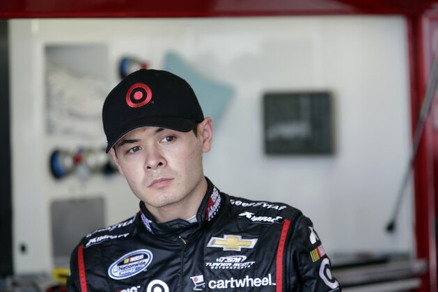 Driver Kyle Larson waits in his garage during practice for the Brickyard 400 Sprint Cup series auto race at the Indianapolis Motor Speedway in Indianapolis, Friday, July 25, 2014. (AP Photo/AJ Mast)