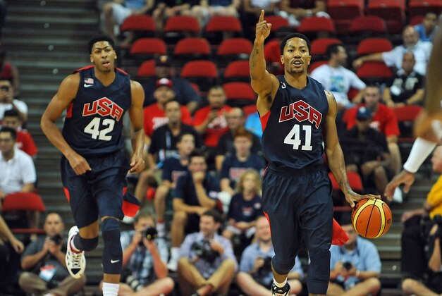 Aug 1, 2014; Las Vegas, NV, USA; USA Team Blue Derrick Rose (41) calls a play while dribbling the ball during the USA Basketball Showcase atThomas & Mack Center. Trailing the play is center Anthony Davis (42). Mandatory Credit: Stephen R. Sylvanie-USA TODAY Sports