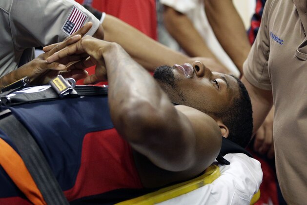 Indiana Pacers' Paul George is taken off the court after he was injured during the USA Basketball Showcase game Friday, Aug. 1, 2014, in Las Vegas. (AP Photo/John Locher)