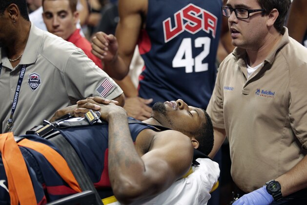 Indiana Pacers' Paul George is taken off the court after he was injured during the USA Basketball Showcase game Friday, Aug. 1, 2014, in Las Vegas. (AP Photo/John Locher)