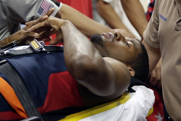Indiana Pacers' Paul George is taken off the court after he was injured during the USA Basketball Showcase game Friday, Aug. 1, 2014, in Las Vegas. (AP Photo/John Locher)