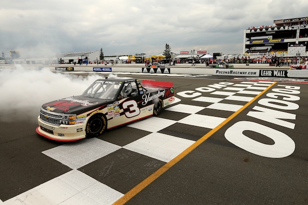 LONG POND, PA - AUGUST 02:  Austin Dillon, driver of the #3 Yuengling Light Lager Chevrolet, celebrates with a burnout after winning the NASCAR Camping World Truck Series Pocono Mountains 150 at Pocono Raceway on August 2, 2014 in Long Pond, Pennsylvania.  (Photo by Elsa/Getty Images)