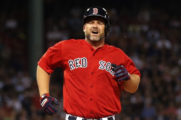 Boston Red Sox catcher David Ross comes up limping after running out a ground ball against the New York Yankees during the sixth inning of a baseball game at Fenway Park in Boston Friday, Aug. 1, 2014. (AP Photo/Winslow Townson)