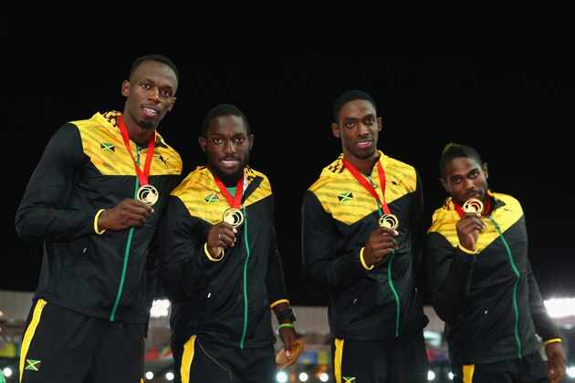 GLASGOW, SCOTLAND - AUGUST 02:  Usain Bolt, Nickel Ashmeade Kemar Bailey-Cole and Jason Livermore of Jamaica pose on the podium during the medal ceremony for the Men's 4x100 metres relay at Hampden Park during day ten of the Glasgow 2014 Commonwealth Games on August 2, 2014 in Glasgow, United Kingdom.  (Photo by Cameron Spencer/Getty Images)