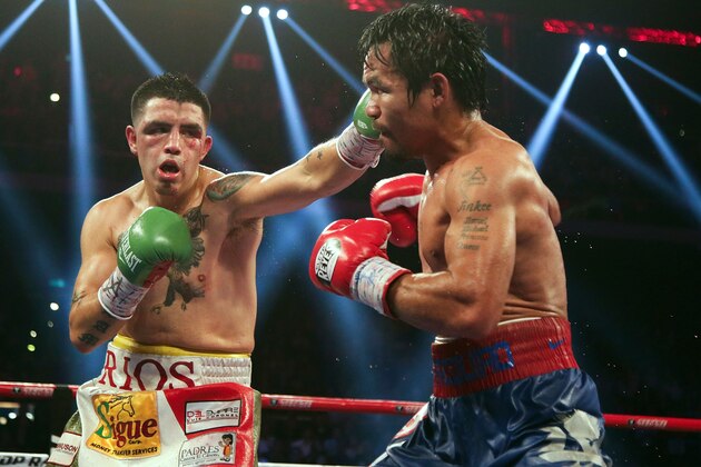 MACAU - NOVEMBER 24:  Manny Pacquiao (R) of the Philippines fights with Brandon Rios of the U.S. during their 'Clash in Cotai' WBO International Welterweight title bout on November 24, 2013 in Macau.  (Photo by Nicky Loh/Getty Images)