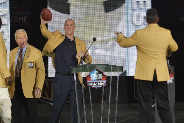 Presenter Marv Levy, left, watches as former Buffalo Bills quarterback Jim Kelly, center, throws a football to inductee Andre Reed during the Pro Football Hall of Fame enshrinement ceremony Saturday, Aug. 2, 2014, in Canton, Ohio. (AP Photo/David Richard) Presenter Marv Levy, left, watches as former Buffalo Bills quarterback Jim Kelly, center, throws a football to inductee Andre Reed during the Pro Football Hall of Fame enshrinement ceremony Saturday, Aug. 2, 2014, in Canton, Ohio. (AP Photo/David Richard)