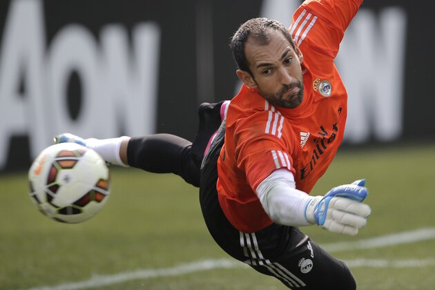 Real Madrid goalkeeper Diego López deflects a shot during training for the their 2014 Guinness International Champions Cup soccer match against Manchester United at Michigan Stadium in Ann Arbor, Mich., Friday, Aug. 1, 2014. (AP Photo/Paul Sancya)