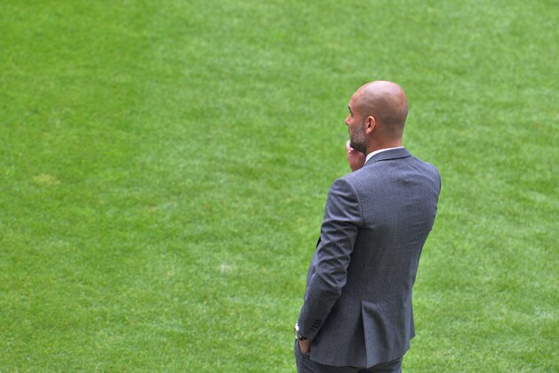Bayern head coach Pep Guardiola  watches his team during the  soccer match between FC Bayern Munich and VfB Stuttgart in the Allianz Arena in Munich, Germany, on Saturday, May 10. 2014. (AP Photo/Kerstin Joensson)