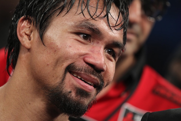 Manny Pacquiao stands in the ring following his victory over Timothy Bradley in their WBO welterweight title boxing fight Saturday, April 12, 2014, in Las Vegas. (AP Photo/Isaac Brekken)