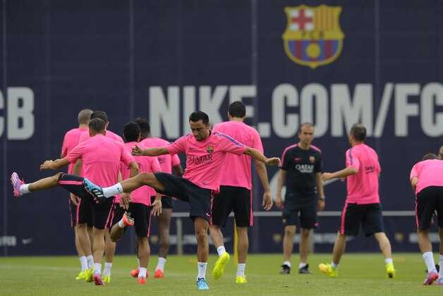 FC Barcelona's Xavi Hernandez, center left, exercises during a training session at the Sports Center FC Barcelona Joan Gamper in San Joan Despi, Spain, Friday, July 25, 2014. (AP Photo/Manu Fernandez) FC Barcelona's Xavi Hernandez, center left, exercises during a training session at the Sports Center FC Barcelona Joan Gamper in San Joan Despi, Spain, Friday, July 25, 2014. (AP Photo/Manu Fernandez)
