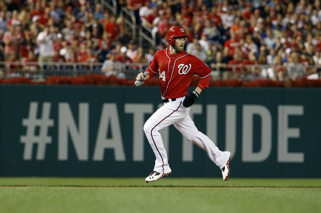 Washington Nationals left fielder Bryce Harper (34) runs to third base during a baseball game against the Philadelphia Phillies at Nationals Park Saturday, Aug. 2, 2014, in Washington. (AP Photo/Alex Brandon)