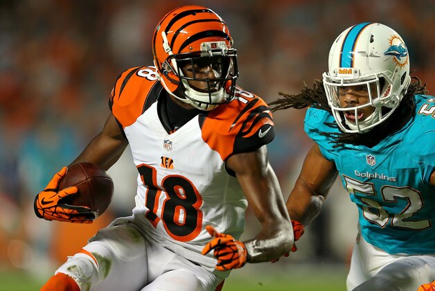 MIAMI GARDENS, FL - OCTOBER 31: A.J. Green #18 of the Cincinnati Bengals is forced out of bounds by Philip Wheeler #52 of the Miami Dolphins during a game at Sun Life Stadium on October 31, 2013 in Miami Gardens, Florida. (Photo by Mike Ehrmann/Getty Images) MIAMI GARDENS, FL - OCTOBER 31: A.J. Green #18 of the Cincinnati Bengals is forced out of bounds by Philip Wheeler #52 of the Miami Dolphins during a game at Sun Life Stadium on October 31, 2013 in Miami Gardens, Florida. (Photo by Mike Ehrmann/Getty Images)