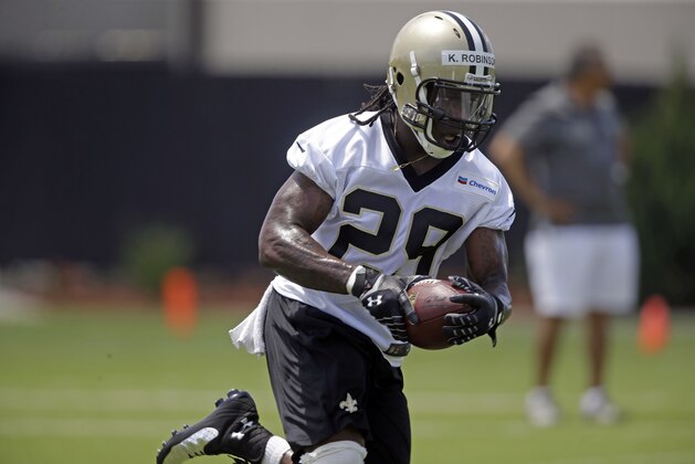 New Orleans Saints running back Khiry Robinson (29) carries during minicamp at their NFL football training facility in Metairie, La., Thursday, June 12, 2014. (AP Photo/Gerald Herbert)