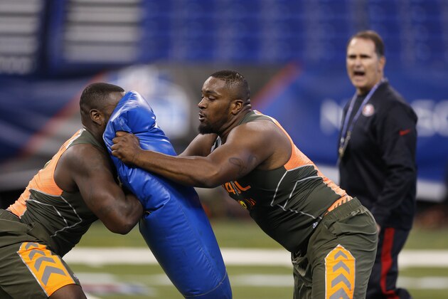 INDIANAPOLIS, IN - FEBRUARY 22: Former Miami offensive lineman Seantrel Henderson (right) runs a blocking drill with former Florida offensive lineman Jonotthan Harrison during the 2014 NFL Combine at Lucas Oil Stadium on February 22, 2014 in Indianapolis, Indiana. (Photo by Joe Robbins/Getty Images)