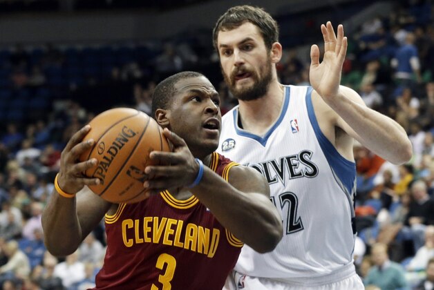 Cleveland Cavaliers' Dion Waiters, left, drives around Minnesota Timberwolves' Kevin Love in the second half of an NBA basketball game Wednesday, Nov. 13, 2013, in Minneapolis. The Timberwolves won 124-95. (AP Photo/Jim Mone)
