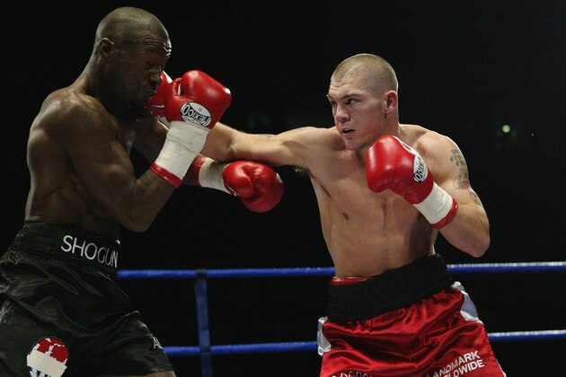MANCHESTER - OCTOBER 18:  Jamie Moore of Great Britain lands with a straight right on Gary Logan of Great Britain during the British and Commonwealth Light Middle-weight fight between Gary Logan of Great Britain and Jamie Moore of Great Britain on October 18, 2003 at the MEN Arena, Manchester.  (Photo by John Gichigi/Getty Images)