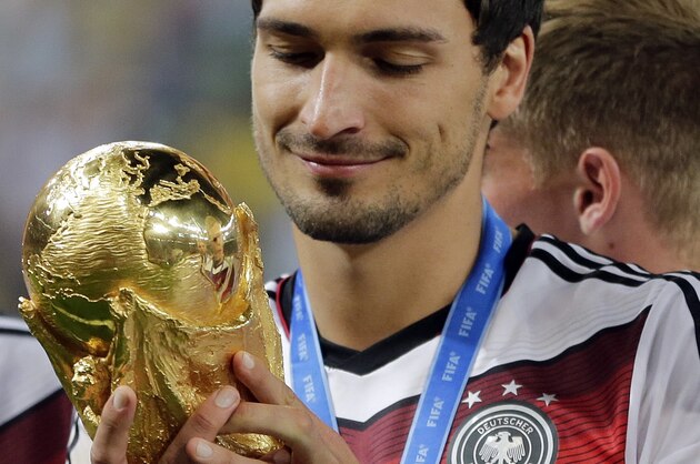 Germany's Mats Hummels holds the trophy after the World Cup final soccer match between Germany and Argentina at the Maracana Stadium in Rio de Janeiro, Brazil, Sunday, July 13, 2014. Germany won the match 1-0. (AP Photo/Matthias Schrader)