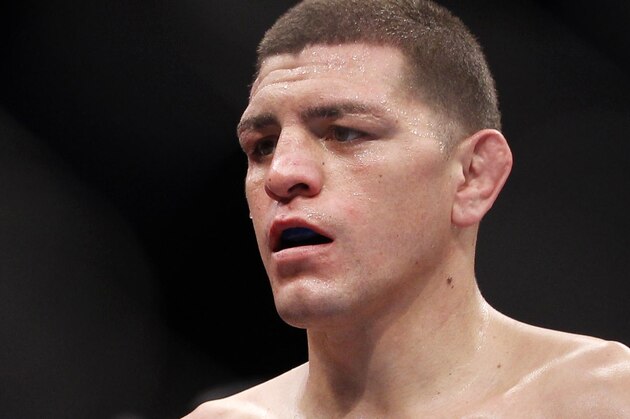 Carlos Condit, left, and Nick Diaz stare each other down as referee Steve Mazzagatti separates them at the end of the third round during their UFC interim welterweight mixed martial arts title match, Saturday, Feb. 4, 2012 at The Mandalay Bay Resort & Casino in Las Vegas. Condit won by unanimous decision. (AP Photo/Eric Jamison)