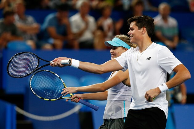 PERTH, AUSTRALIA - DECEMBER 28:  Milos Raonic and Eugenie Bouchard of Canada talk inbetween play in the mixed doubles match against Sam Stosur and Bernard Tomic of Australia during day one of the 2014 Hopman Cup at Perth Arena on December 28, 2013 in Perth, Australia.  (Photo by Will Russell/Getty Images)