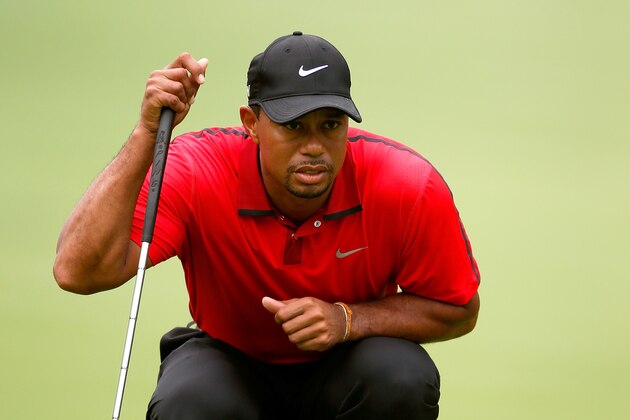 AKRON, OH - AUGUST 03:  Tiger Woods lines up a putt on the first green during the final round of the World Golf Championships-Bridgestone Invitational at Firestone Country Club South Course on August 3, 2014 in Akron, Ohio.  (Photo by Gregory Shamus/Getty Images)