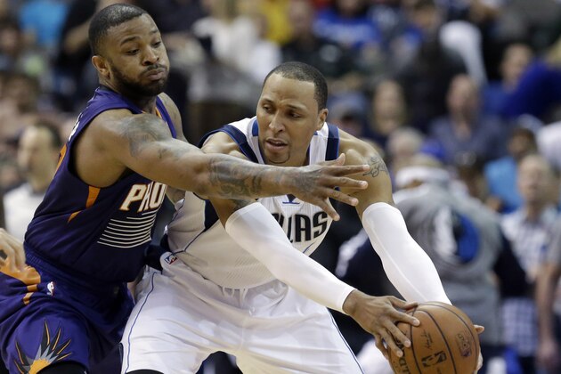 Dallas Mavericks forward Shawn Marion, right, keeps the ball from Phoenix Suns forward P.J. Tucker, left, during the first half of an NBA basketball game on Saturday, April 12, 2014, in Dallas. (AP Photo/LM Otero)