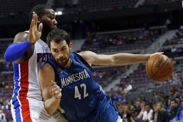 Minnesota Timberwolves power forward Kevin Love (42) drives against Detroit Pistons center Greg Monroe in the first half of their preseason NBA basketball game in Auburn Hills, Mich., Thursday, Oct. 24, 2013. (AP Photo/Paul Sancya)