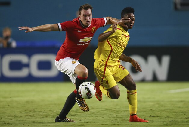 Manchester United Phil Jones (left) and Liverpool Raheem Sterling (31) battle for the ball during the finals of the Guinness International Championship Cup soccer match in Miami, Gardens, Fla., Monday, July 4, 2014. (AP Photo/J Pat Carter)