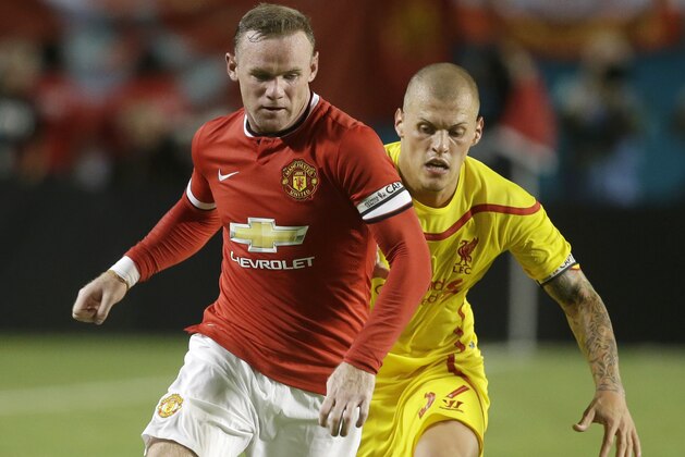 Manchester United forward Wayne Rooney, left, runs with the ball as Liverpool defender Martin Skrtel, right, defends in the second half during the final of the Guinness International Champions Cup soccer match, Monday, Aug. 4, 2014, in Miami Gardens, Fla. Manchester United defeated Liverpool 3-1. (AP Photo/Lynne Sladky) Manchester United forward Wayne Rooney, left, runs with the ball as Liverpool defender Martin Skrtel, right, defends in the second half during the final of the Guinness International Champions Cup soccer match, Monday, Aug. 4, 2014, in Miami Gardens, Fla. Manchester United defeated Liverpool 3-1. (AP Photo/Lynne Sladky)