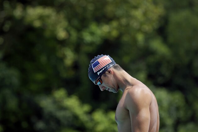 In this July 31, 2014 photo, Michael Phelps pauses before a training session at Meadowbrook Aquatic and Fitness Center in Baltimore. This is where Phelps put in most of the work to become the most decorated athlete in Olympic history. This is where he's looking to add to that legacy after an aborted retirement, his eyes firmly on the Rio Games two years away. (AP Photo/Patrick Semansky)