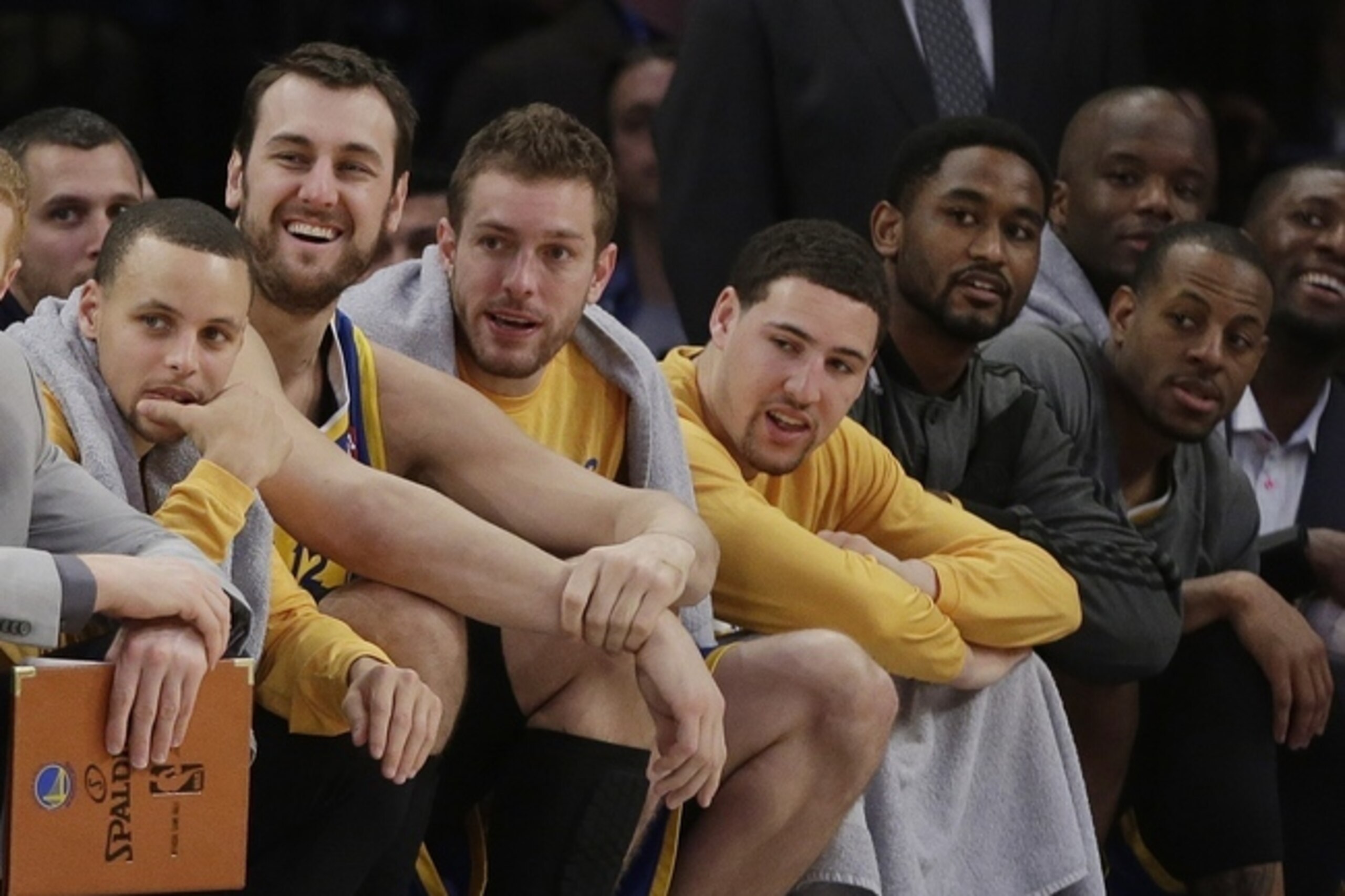 Golden State Warriors' Stephen Curry, left, watches during the second half of an NBA basketball game against the New York Knicks with teammates Andrew Bogut, second from left, David Lee, center, Klay Thompson, third from right, and Andre Iguodala, right, Friday, Feb. 28, 2014, in New York. The Warriors won the game 126-103. (AP Photo/Frank Franklin II)