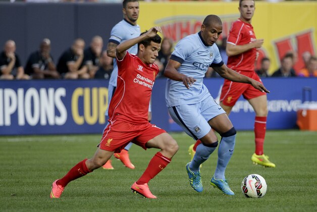 Liverpool midfielder Philippe Coutinho (10), left, challenges Manchester City midfielder Fernando (6) in the first half of a Guinness International Champions Cup soccer tournament match, Wednesday, July 30, 2014, at Yankee Stadium in New York. (AP Photo/Julie Jacobson)
