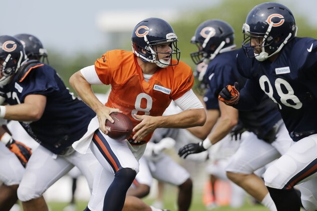 Chicago Bears quarterback Jimmy Clausen (8) looks to a pass during NFL football training camp at Olivet Nazarene University, Wednesday, July 30, 2014, in Bourbonnais, Ill. (AP Photo/Nam Y. Huh)