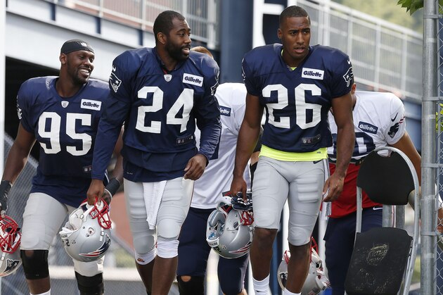 New England Patriots defensive end Chandler Jones (95), cornerback Darrelle Revis (24) and cornerback Logan Ryan (26) come on the field for NFL football training camp in Foxborough, Mass., Saturday, July 26, 2014. (AP Photo)